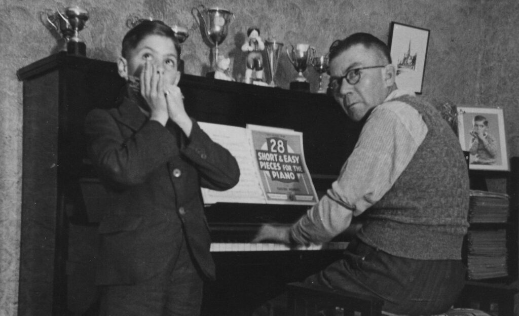 1938 Jack playing harmonica with father William at the piano