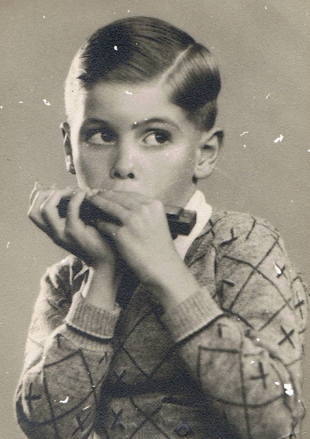 Young Jack Harrison playing harmonica, 1938